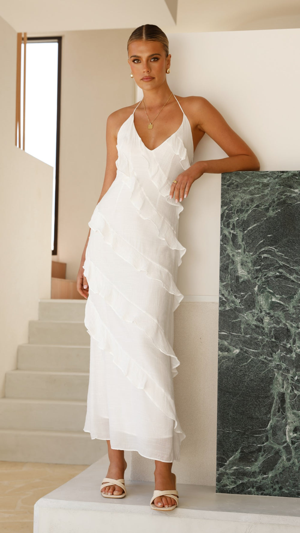 Modern, lightweight long dress with fine drawstring at the neckline and diagonal ruffles