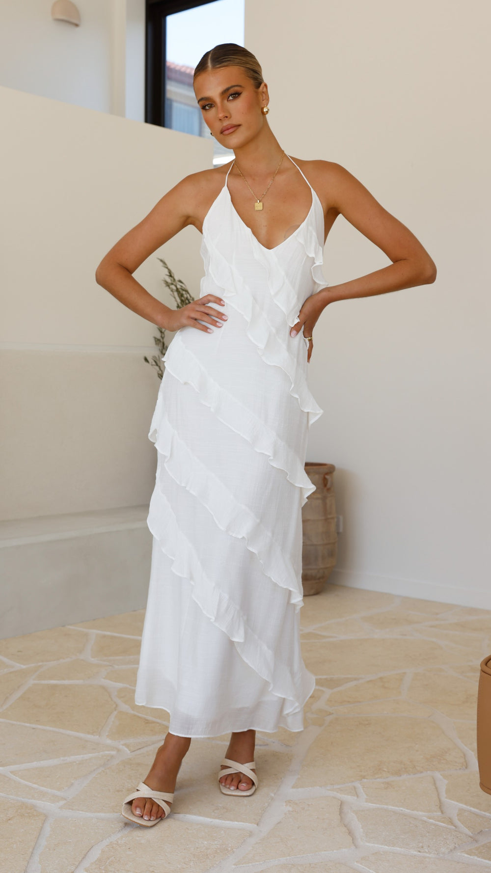 Modern, lightweight long dress with fine drawstring at the neckline and diagonal ruffles