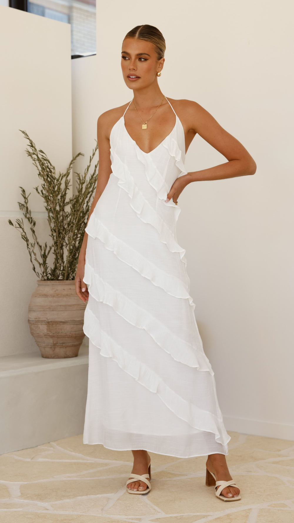Modern, lightweight long dress with fine drawstring at the neckline and diagonal ruffles