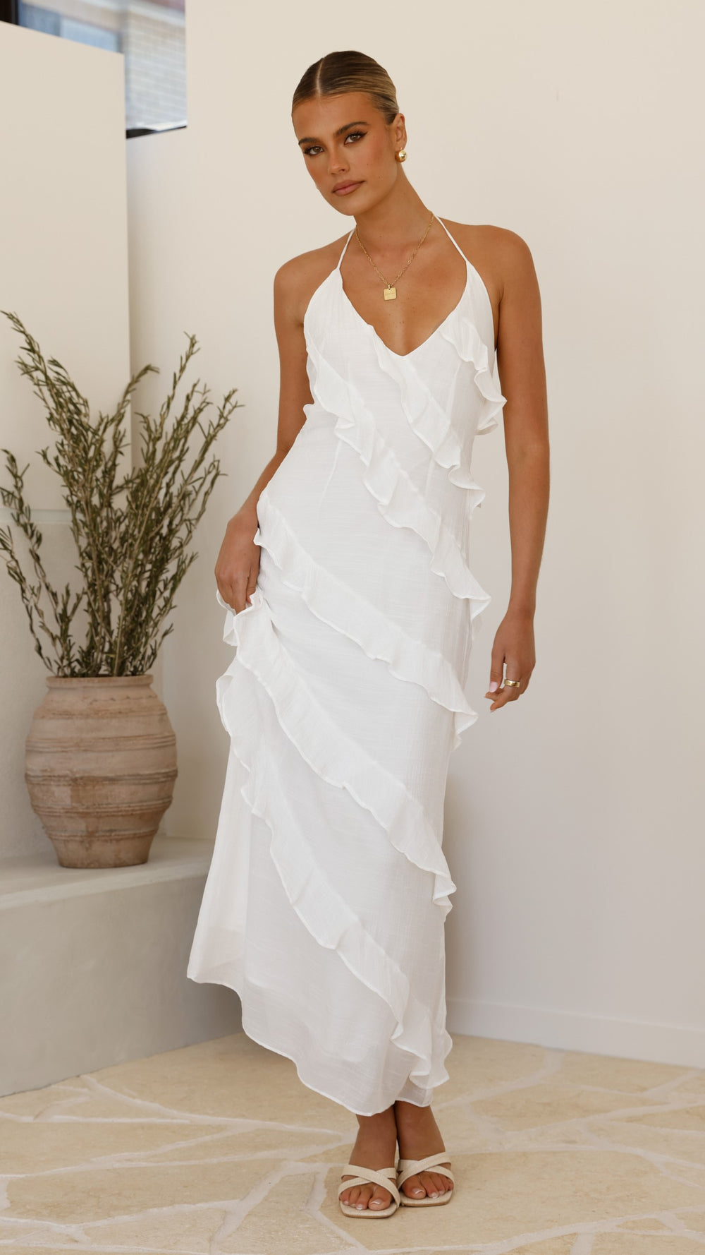Modern, lightweight long dress with fine drawstring at the neckline and diagonal ruffles