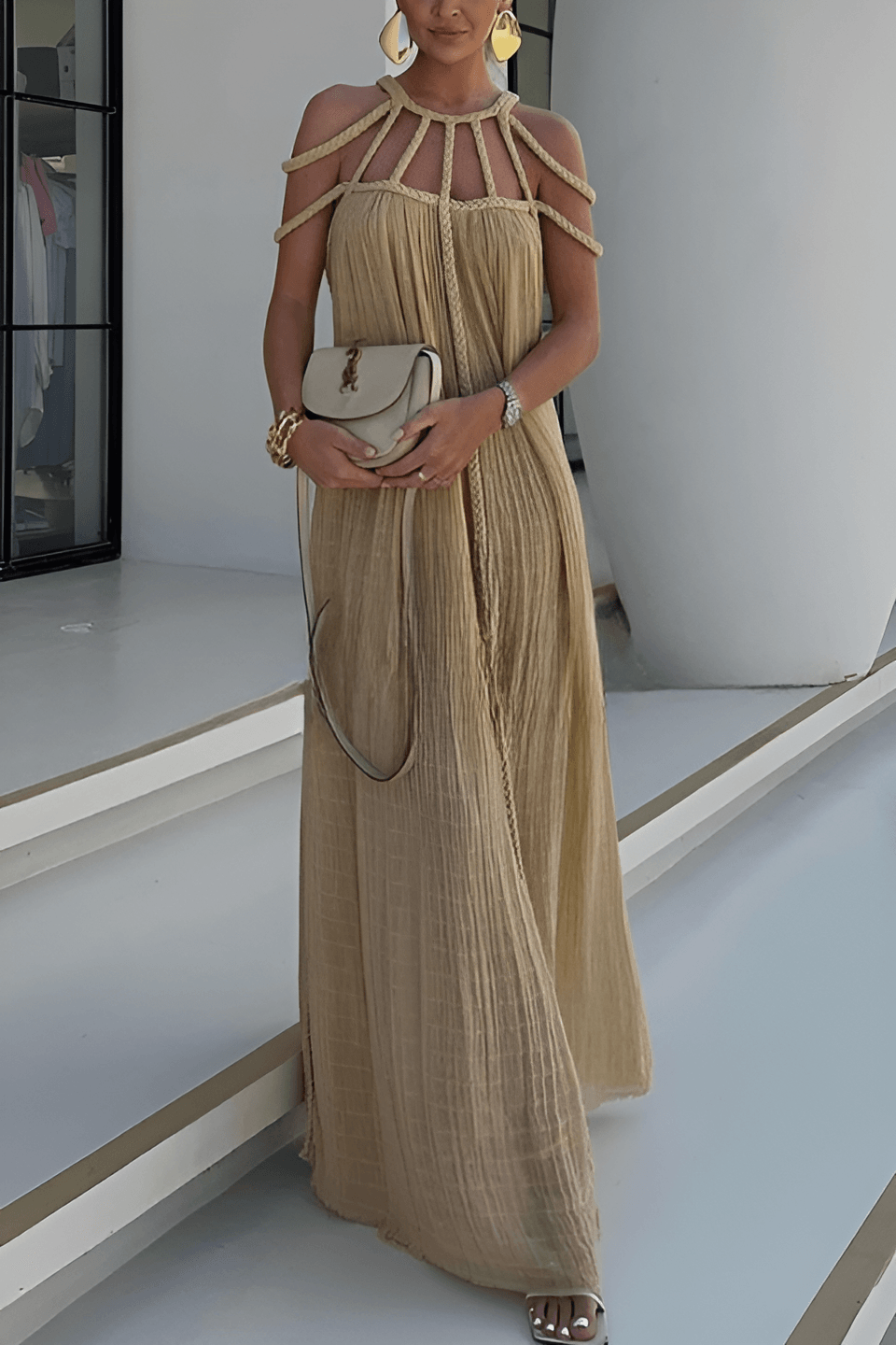 Long pleated dress with cord detailing and an artistic neckline