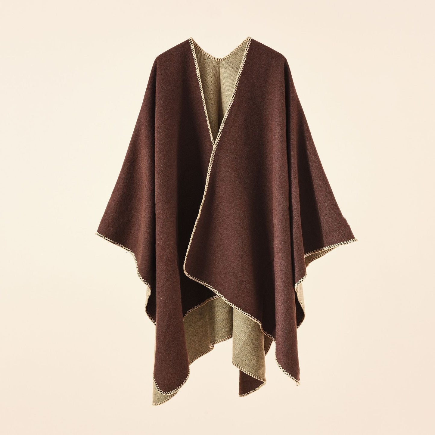 Women's knitted poncho with an asymmetrical cut and high thermal insulation