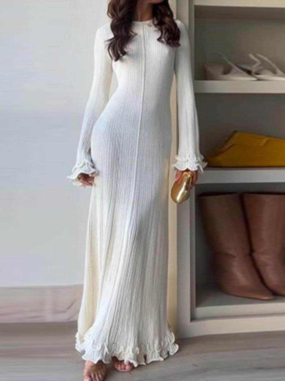 Elegant knitted maxi dress with trumpet sleeves, folded hem, and a round neckline