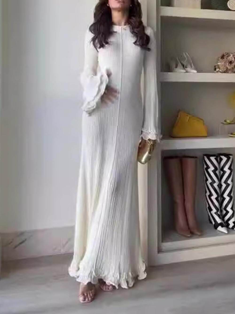 Elegant knitted maxi dress with trumpet sleeves, folded hem, and a round neckline