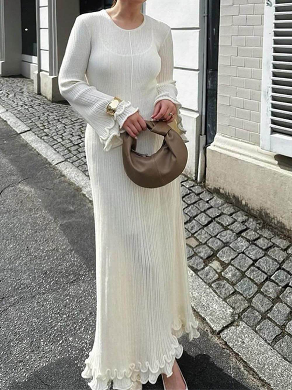 Elegant knitted maxi dress with trumpet sleeves, folded hem, and a round neckline
