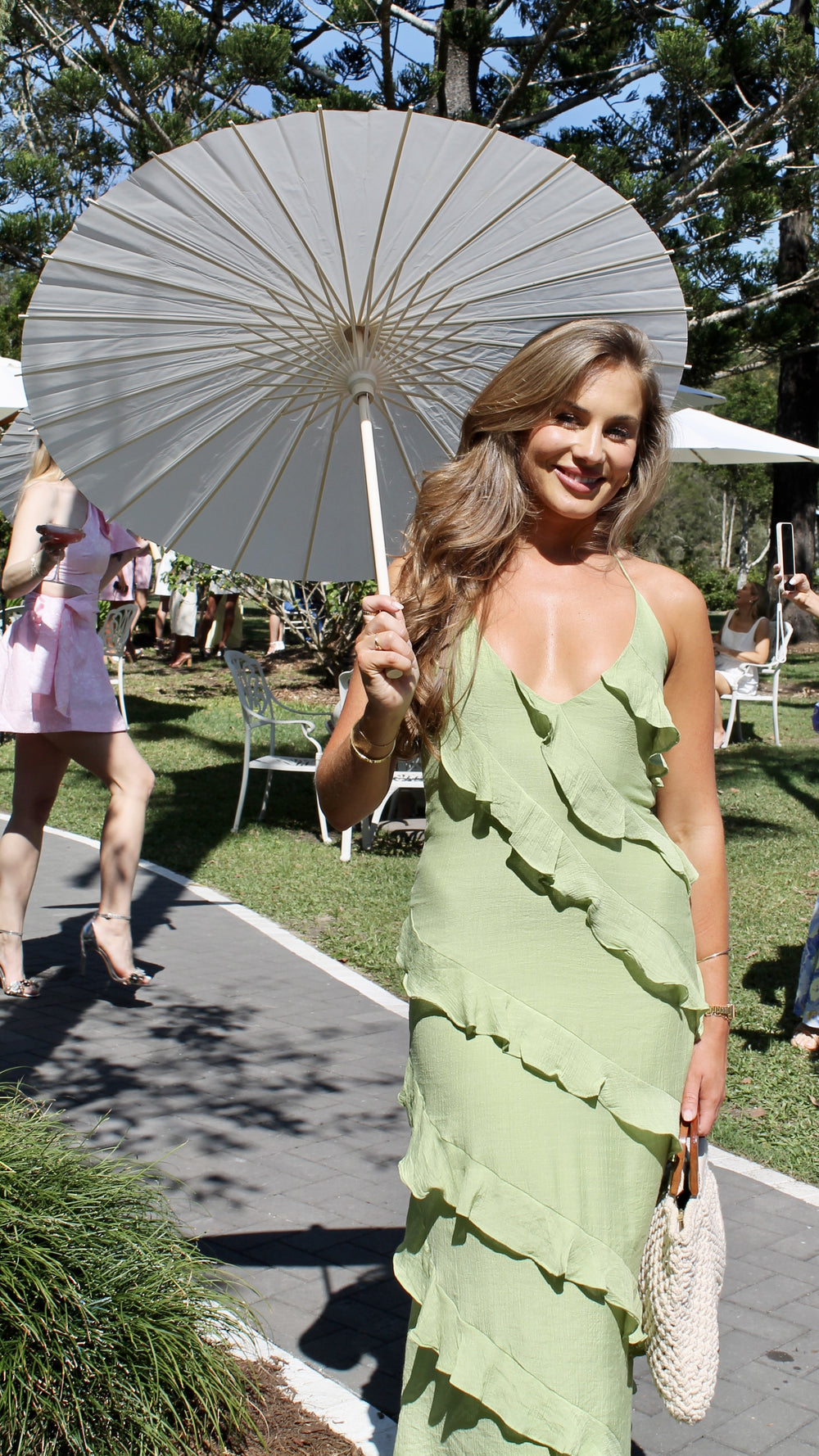 Modern, lightweight long dress with fine drawstring at the neckline and diagonal ruffles